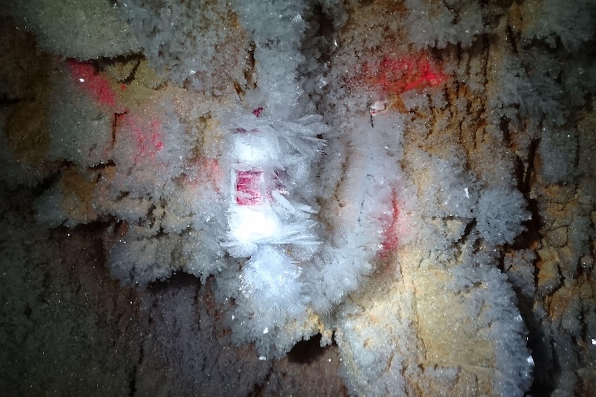 Icy crystals all over the inside of a cave tunnel