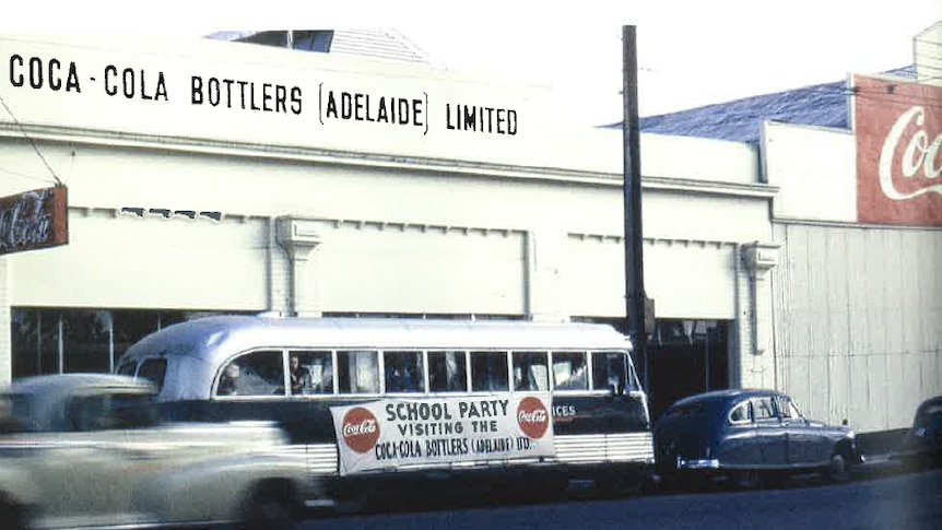 an old photo of a factory with coca cola on it