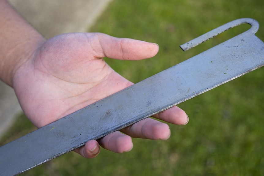 A machete-like instrument, with a think hook protruding from the top of the blade.