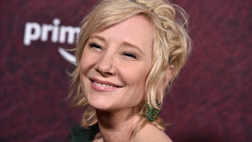 Anne Heche smiles toward the camera at a red carpet event