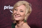Anne Heche smiles toward the camera at a red carpet event