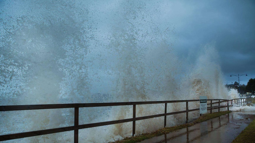 A large wave hits and splashes up over the Penguin foreshore.