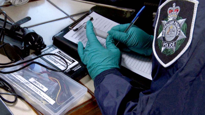 An Australian Federal Police officer organises evidence