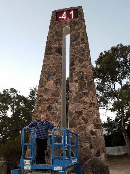 Stanthorpe Chamber of Commerce vice president Mick Spiller at the Big Thermometer showing -4.1 temperature.