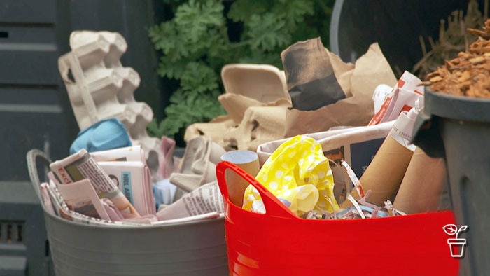 Coloured plastic tubs filled with a range of materials for composting