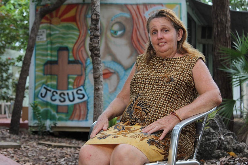 A photo of pastor Sharon Crook sitting in a chair at the church.