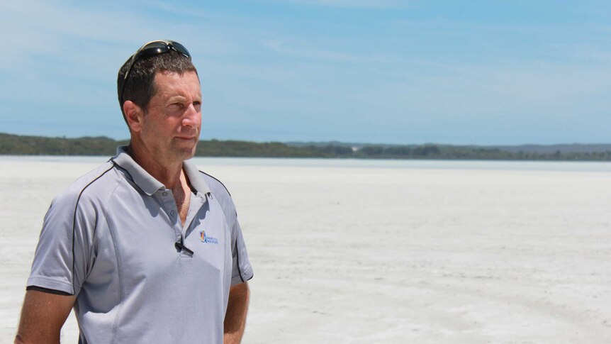 State conservation officer Steven Butler standing at Pink Lake, which is now white.