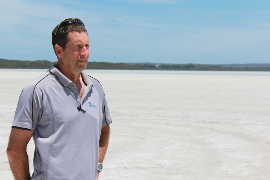 State conservation officer Steven Butler standing at Pink Lake, which is now white.