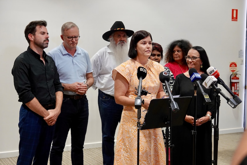 NT Chief Minister Natasha Fyles speaking at a press conference, surrounded by several other politicians.