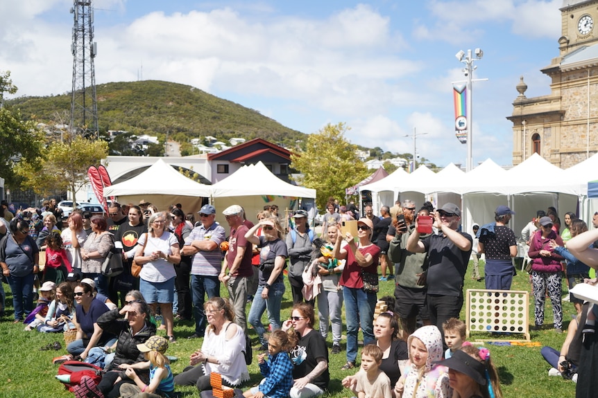 crowd in park in front of mountain 