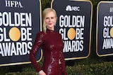 Nicole Kidman wearing a red dress at the Golden Globes red carpet.