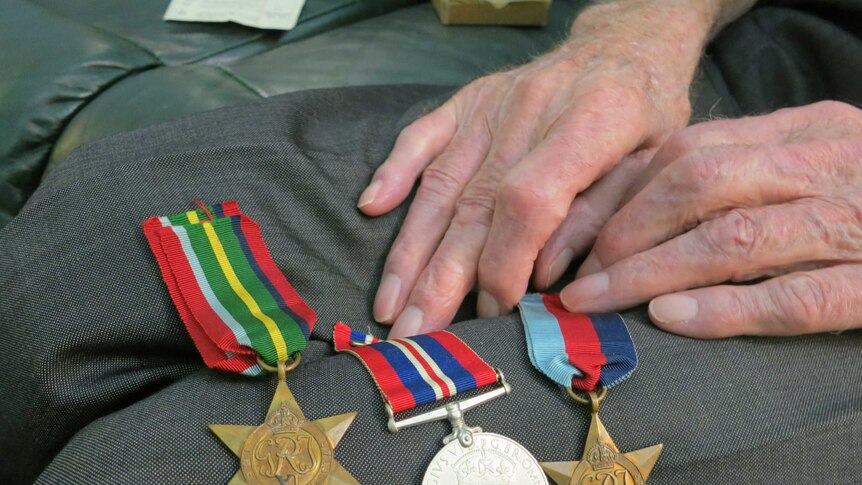 John Craig displays his military medals at his Sydney home