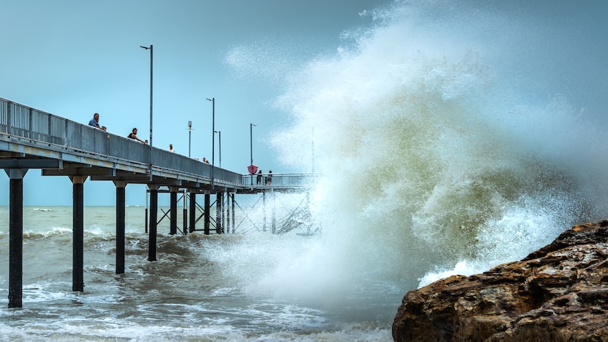 waves crashing into a jetty