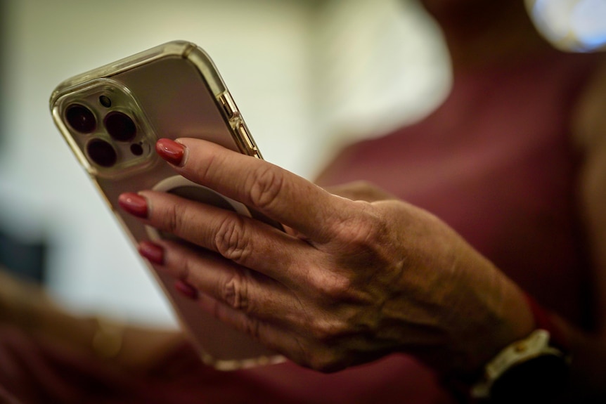 A close-up of Michelle's hands holding her phone.
