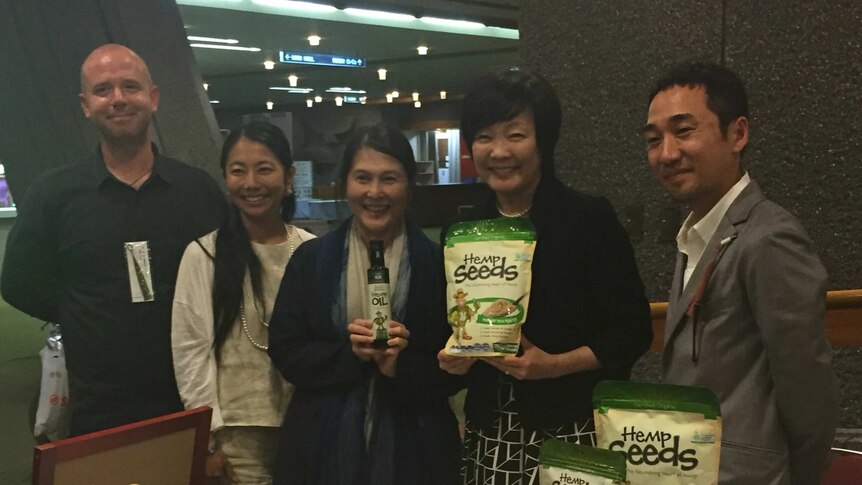 Japan's First Lady Akie Abe holds a packed of hemp seeds.