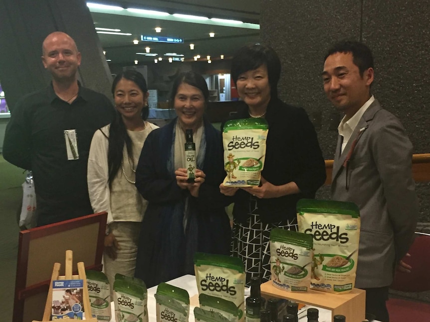 Japan's First Lady Akie Abe holds a packed of hemp seeds.