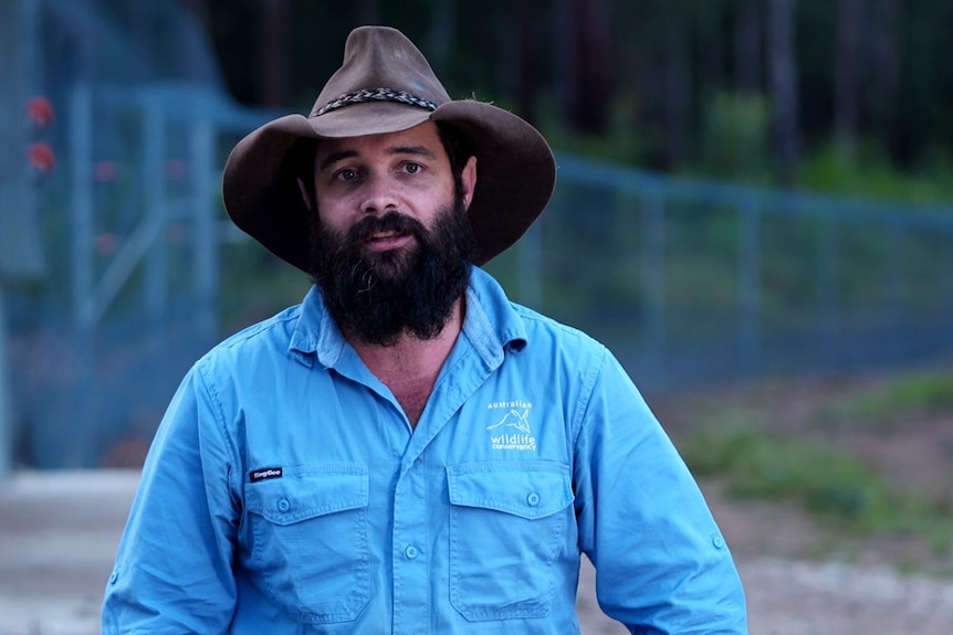 John McAlister wears a blue Australian Wildlife Conservancy uniform