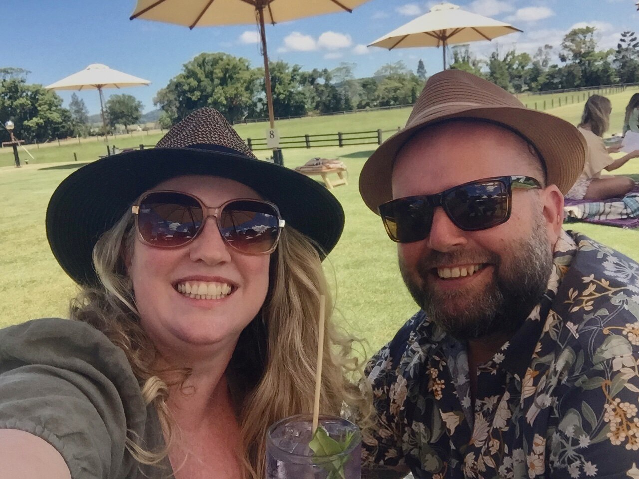 Vanessa Phillips and her husband Craig, pictured similing wearing sunglasses and hats.