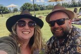 Vanessa Phillips and her husband Craig, pictured similing wearing sunglasses and hats.