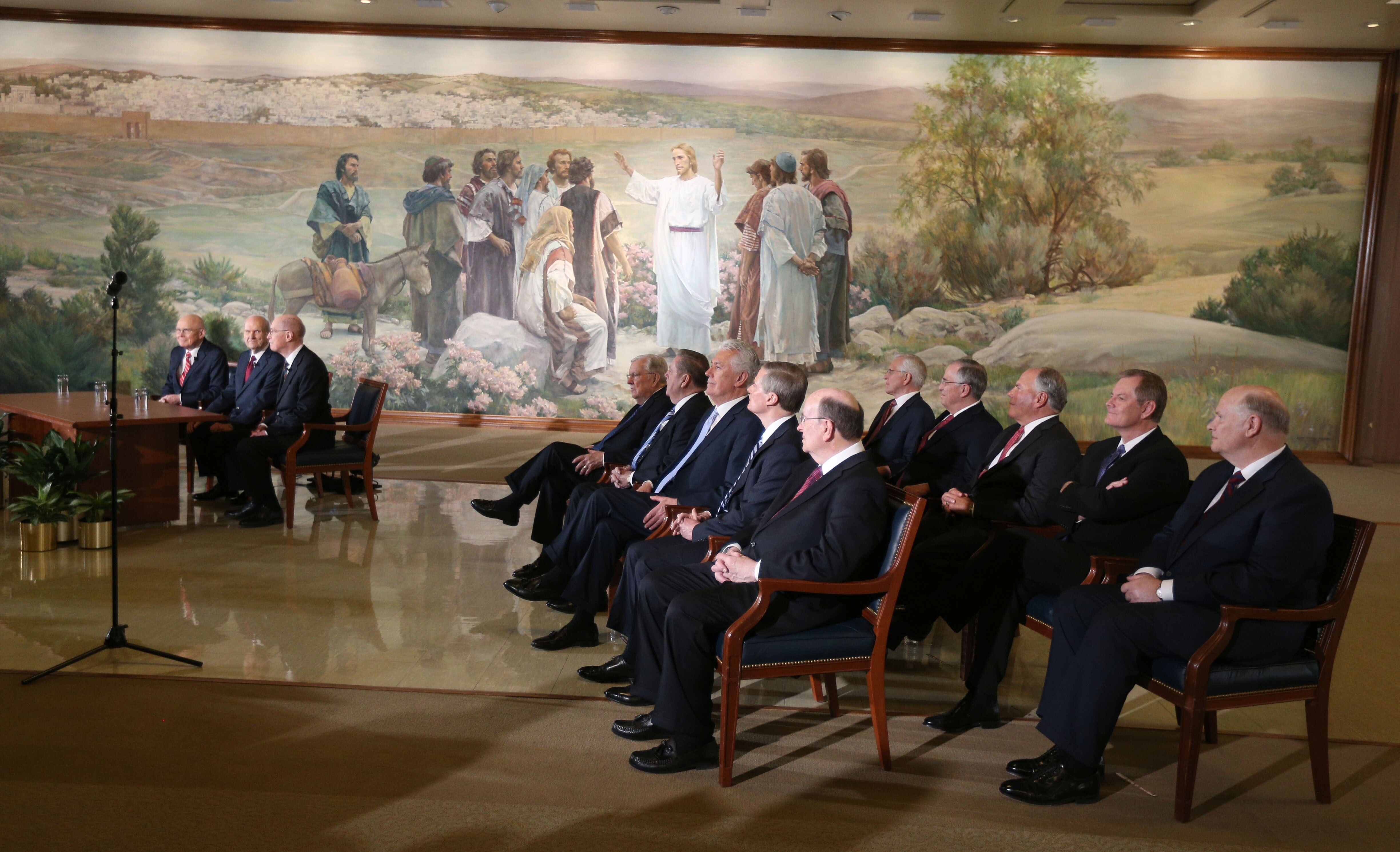 Mormon Apostles sit to the side listening to President Russell M. Nelson of the Church of Jesus Christ of Latter-Day Saints