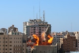 Flames emerge from a building hit by Israeli forces