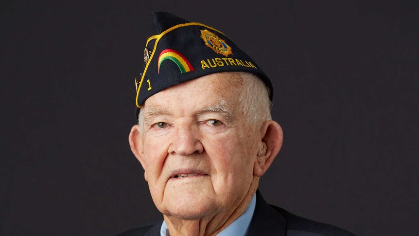 Portrait of an elderly man wearing war medals and a navy hat