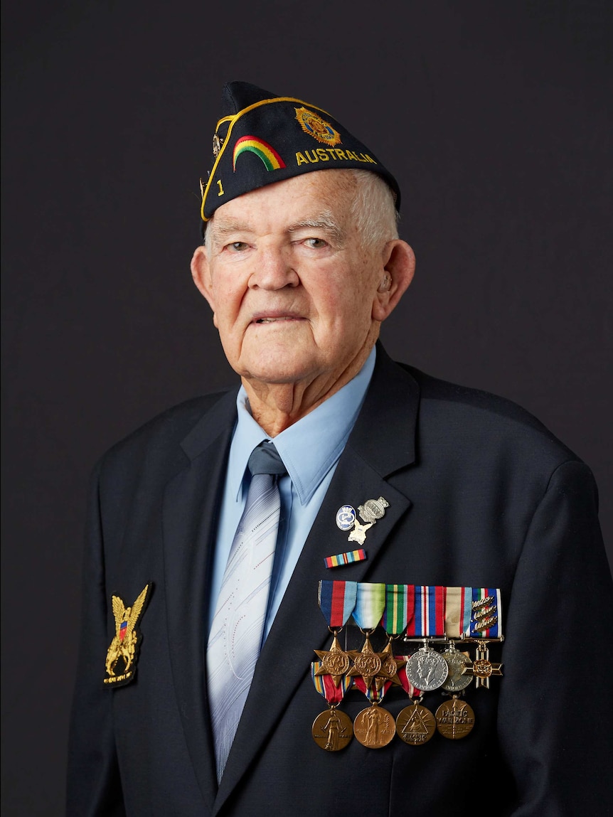 Portrait of an elderly man wearing war medals and a navy hat