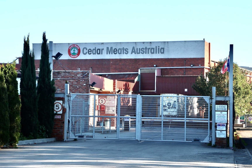 A red-brick building with a white 'Cedar Meats Australia' sign at the top.