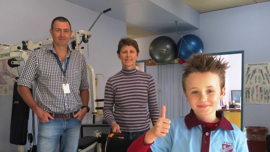 Physio Justin Griffiths, with Kim Anderson and her son Rusty Gielis