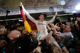 Mercedes driver Nico Rosberg celebrates winning 2016 F1 world title after the Abu Dhabi Grand Prix.
