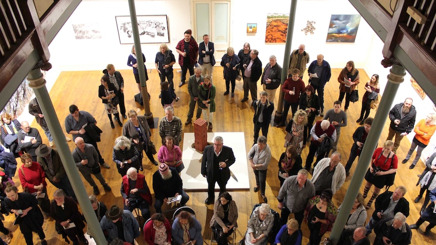 A crowd listens to the winner of the 2017 Pro Hart Outback Art Prize being announced at the Broken Hill art gallery.