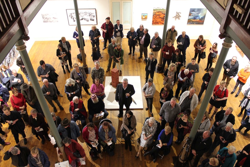 A crowd listens to the winner of the 2017 Pro Hart Outback Art Prize being announced at the Broken Hill art gallery.