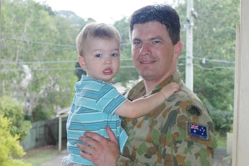 Brad Campbell at home with his son