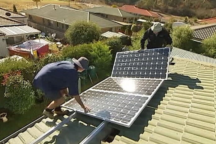 Installing solar panels on a house in Sydney