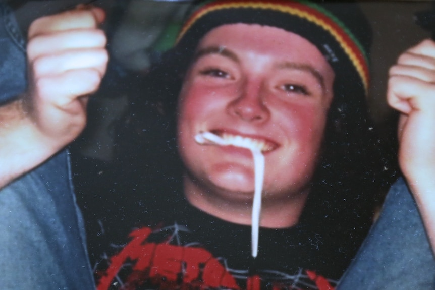 Head and shoulders picture of a young man grinning.