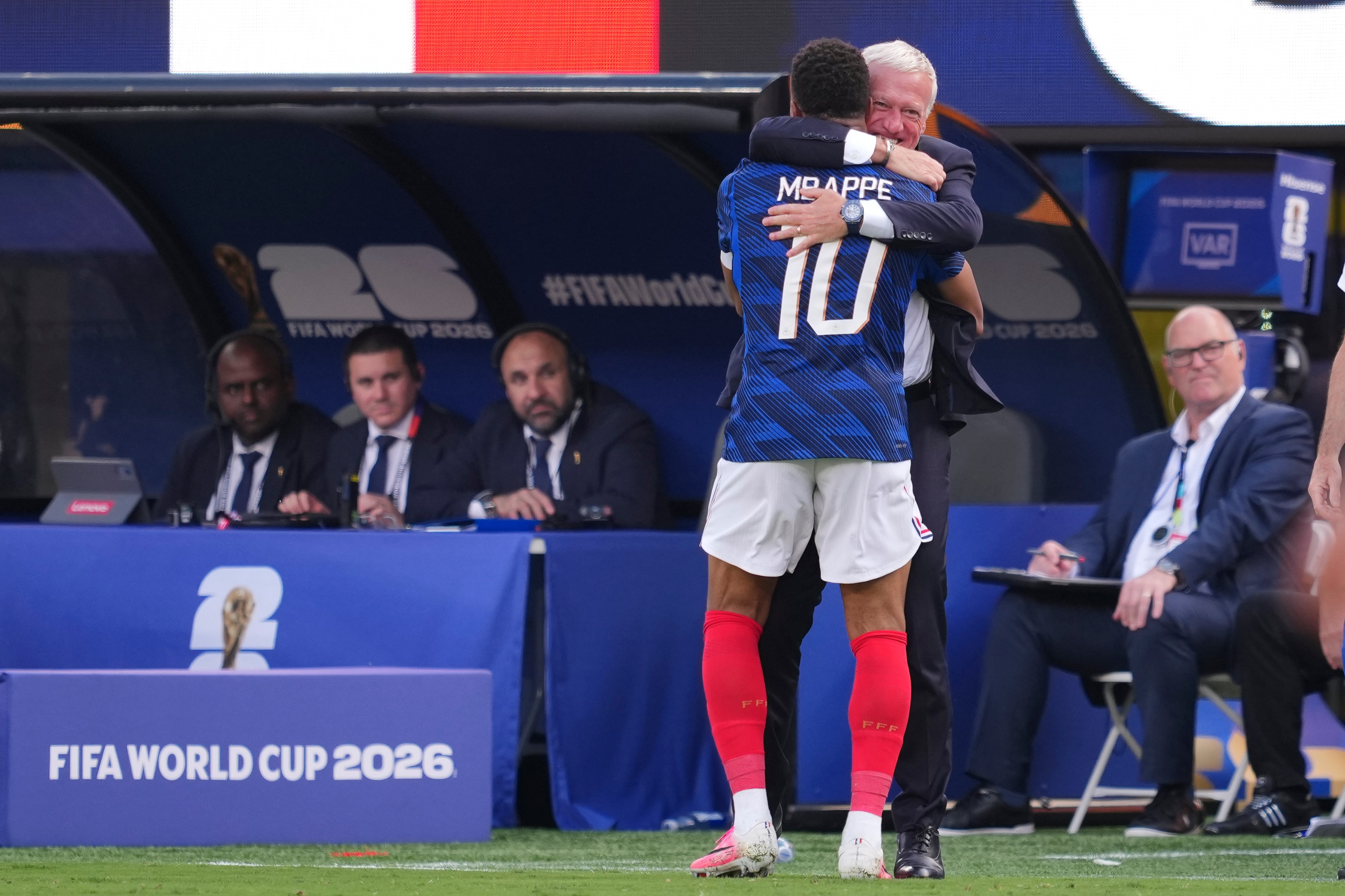 France coach Didier Deschamps embraces Kylian Mbappe after he scores a goal
