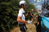 Italy's Gianni Moscon waits for a spare bicycle after crashing on stage nine of the Tour de France.