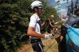 Italy's Gianni Moscon waits for a spare bicycle after crashing on stage nine of the Tour de France.