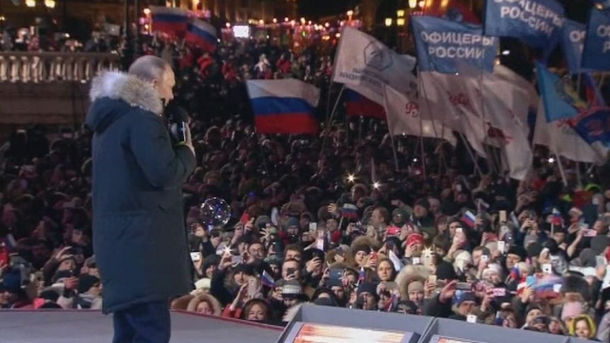 Putin celebrates election victory at a rally in Moscow