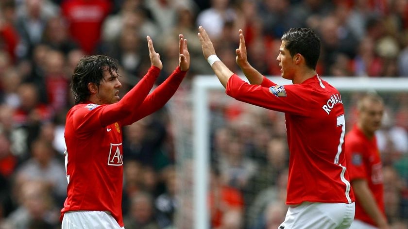 LtoR Manchester United's Cristiano Ronaldo congratulates team-mate Carlos Tevez after Tevez scored
