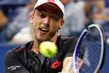 John Millman hits a ball during his match with Roger Federer.