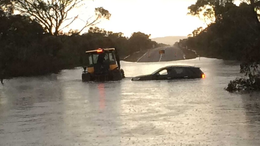Steven Hall towing a car submerged in water on the South Coast Highway