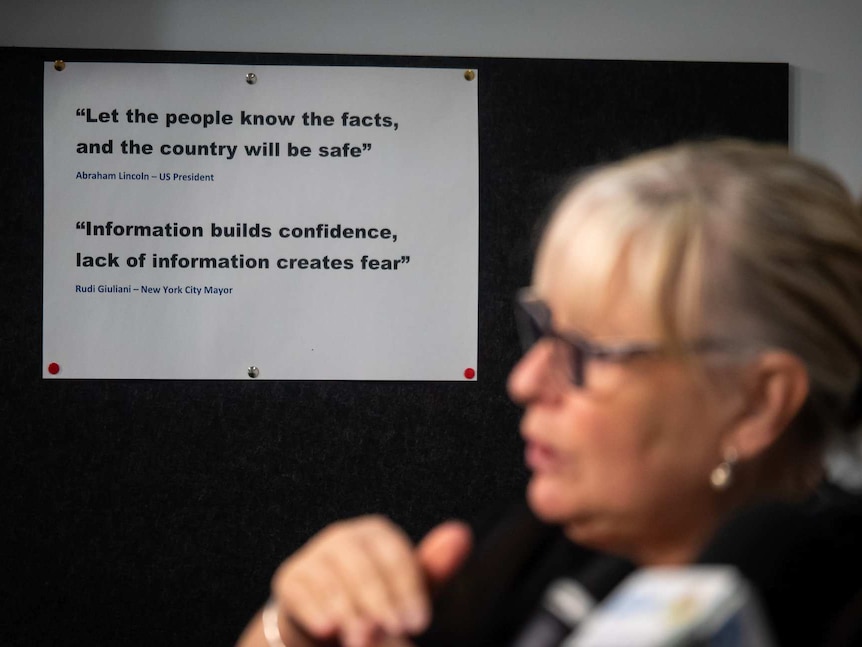 The side profile of a female Auslan interpreter. In the background are quotes about the importance of emergency information.