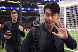 Tottenham Hotspur's Son Heung-Min waves to fans as he arrives for a Champions League game against AC Milan.