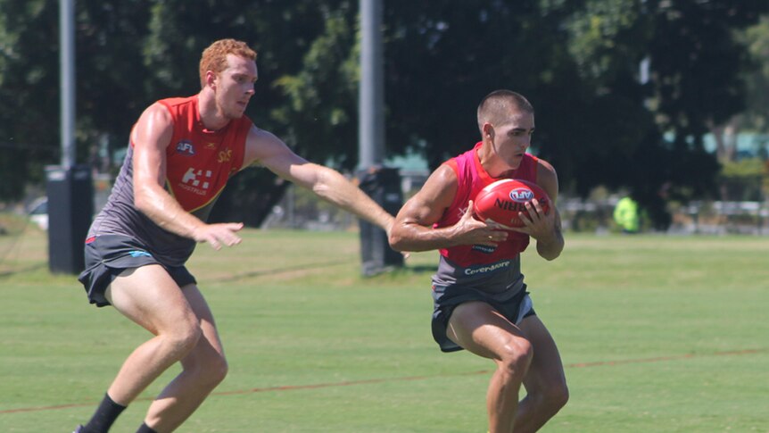 Gold Coast Suns player Rory Thompson tackles Jacob Dawson at AFLX trial practice