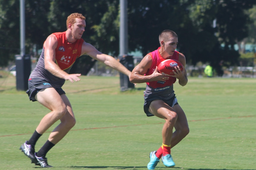 Gold Coast Suns player Rory Thompson tackles Jacob Dawson at AFLX trial practice