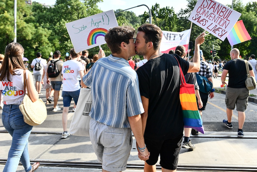 Participants kiss during a gay pride parade in Budapest