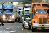Trucks crawl through a central Sydney street