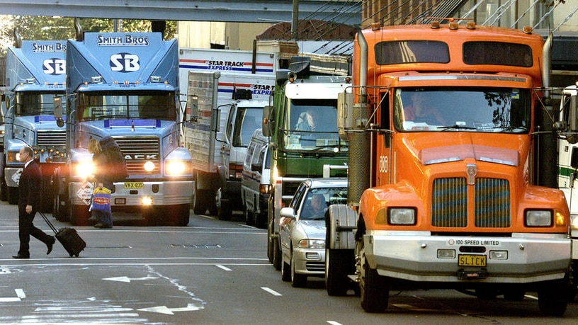 Trucks crawl through a central Sydney street