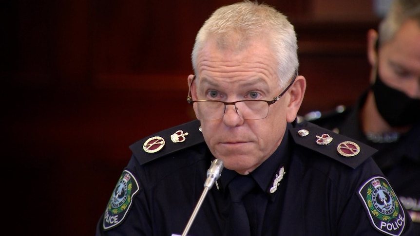 Grant Stevens sitting behind a microphone on a desk